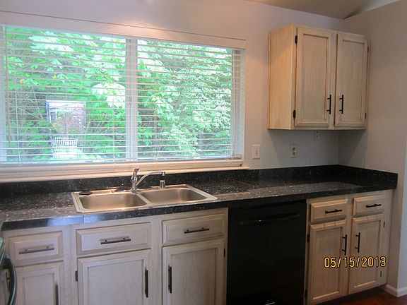 Kitchen includes brand new cabinets, granite, and peaceful greenbelt view