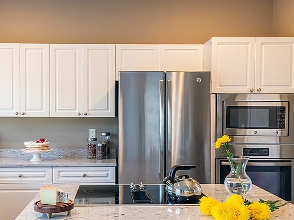 Kitchens feature custom touches like kitchen islands and breakfast bars