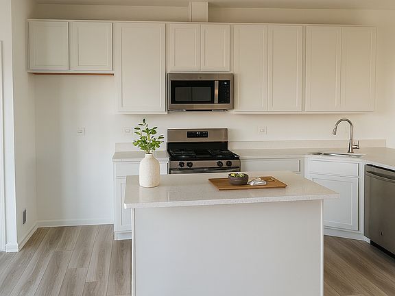 Chef's quartz kitchen with 42_ cabinets, stainless-steel appliances, and oversized center island