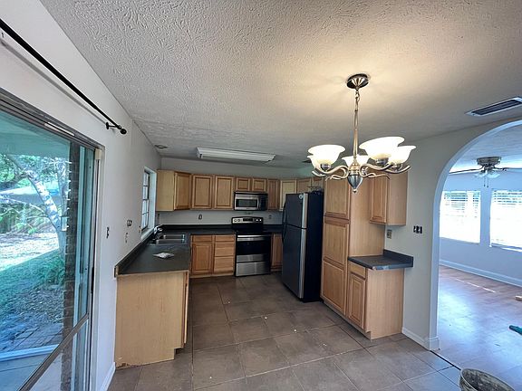 Tile kitchen, slide open glass door to screened in porch.