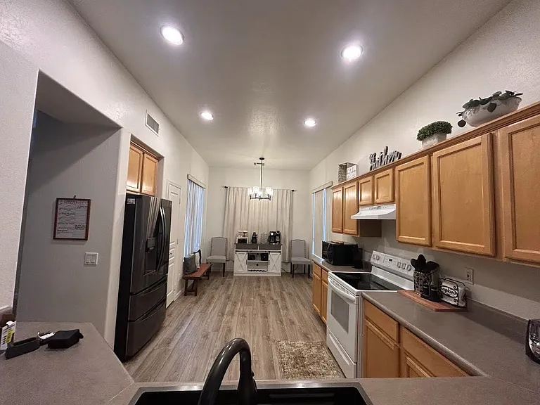 Large kitchen area furnished with everything you need, plates, cups, pots/pans, utensils. New large refrigerator with ice dispenser, water filter.