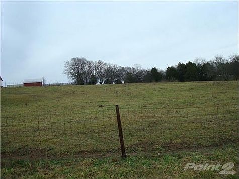 From street looking uphill. Barn is on neighbor's property.