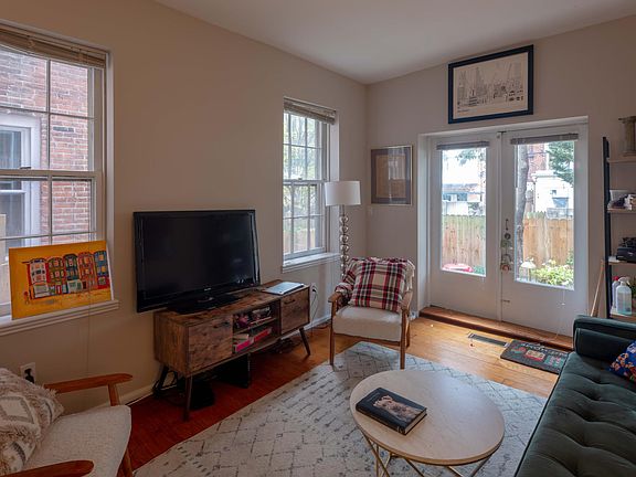 Living room with french doors opening out on to private garden