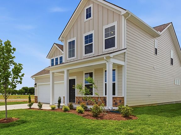 Home Exterior with two types of paneling and two car garage