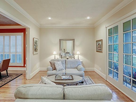 The formal living room is located off the front of the home and showcases oversized windows overlooking the beautifully landscaped front yard.