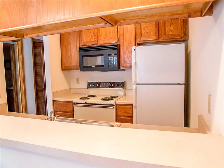 Cook up your favorites in a practical kitchen with full-size appliances, ample cabinet storage, and a convenient pass-through counter.