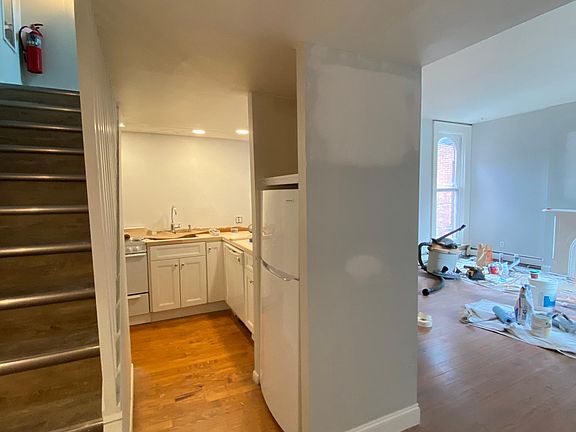 Entering the unit. Open concept kitchen & living room space.