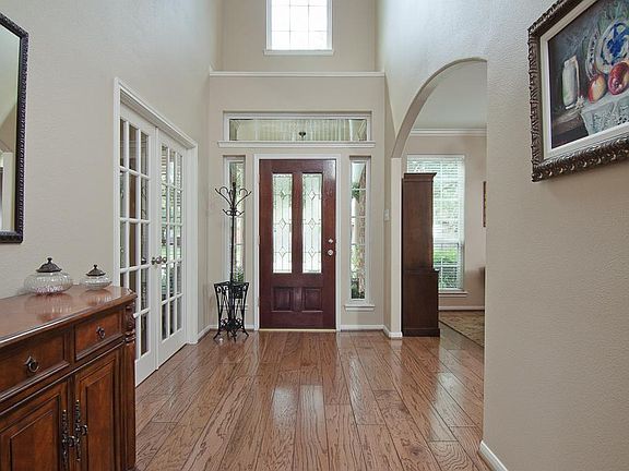 Hand-scraped hardwood floors and a soaring two-story entry greet you as you enter the home. A decorative archway leads to the dining room and French doors lead to the separate study.