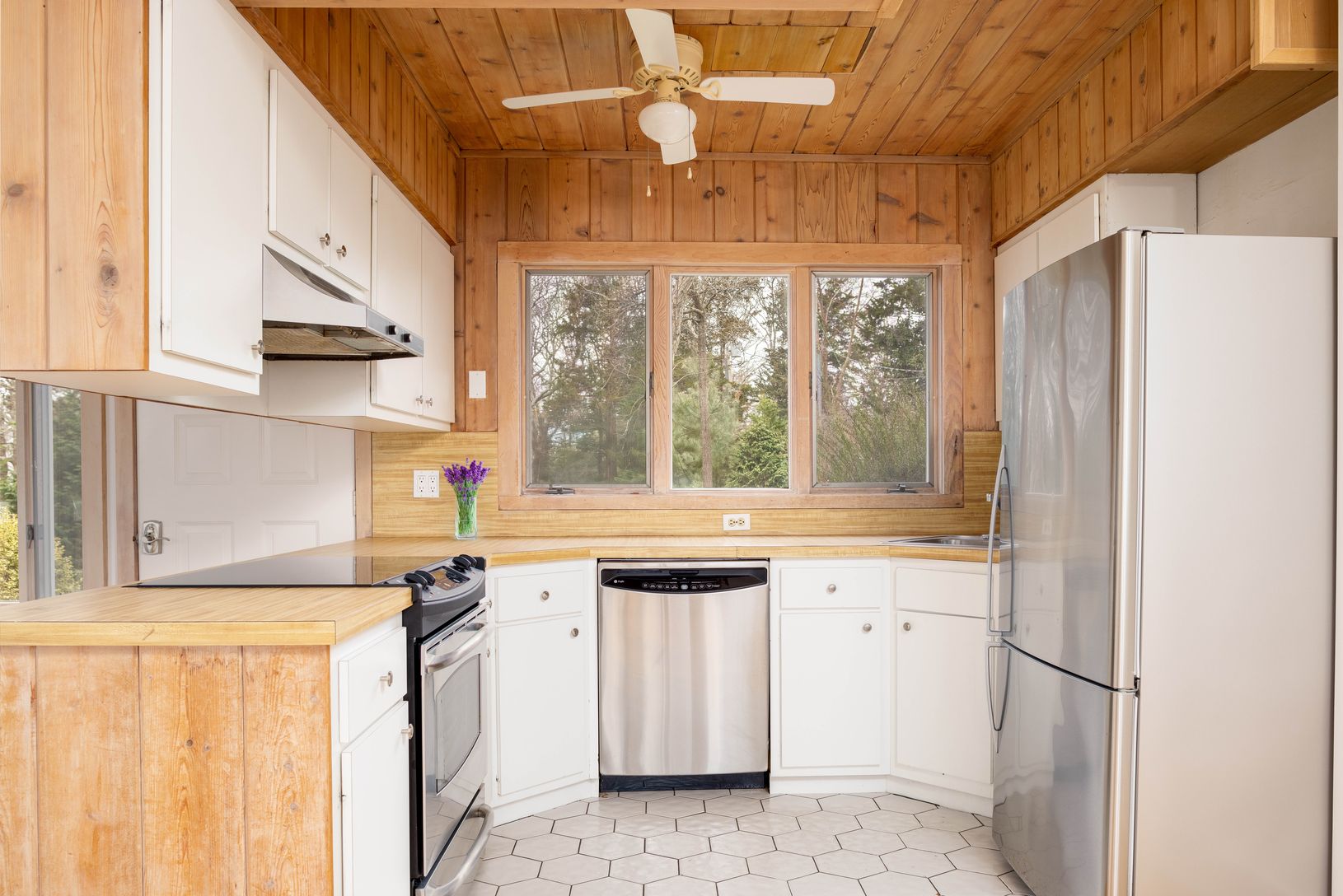  Kitchen with stainless steel appliances & white cabinets