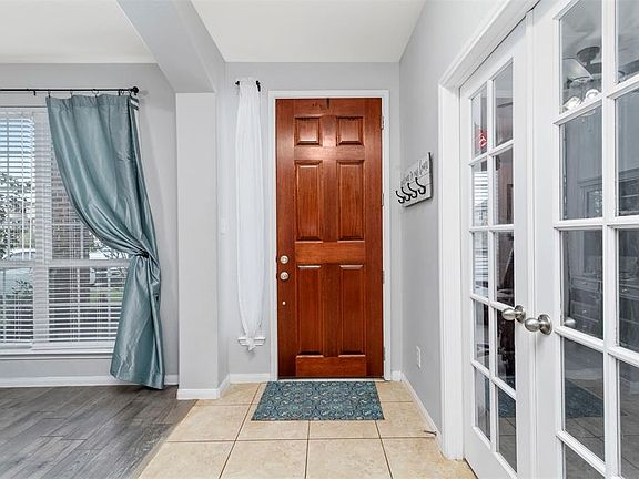 Upon entry the Custom built ins with Library is the the right and the dedicated office with French doors to the left