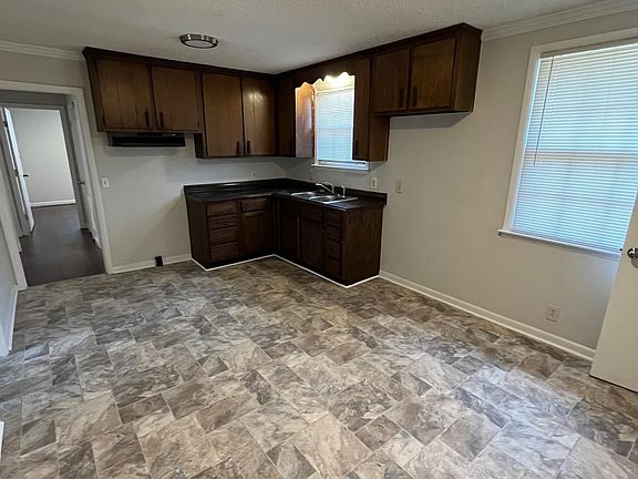 standing in the dining area of kitchen