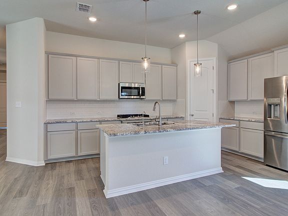 Kitchen Featuring Pendant Lighting, Stunning Countertops, Stainless Steel Appliances, Gas Cooking