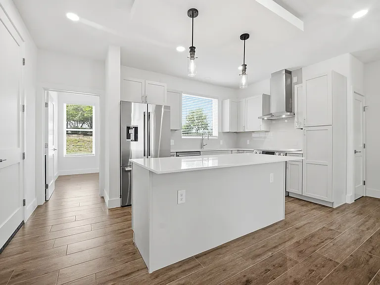 Abundant counter space and cabinetry, plus a well-designed pantry cabinet with convenient pull-out drawers for added storage.