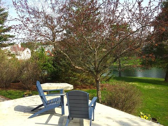 View of backyard from the deck including the pond.