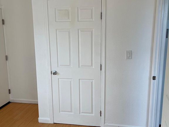 Bedroom has exit door to backyard