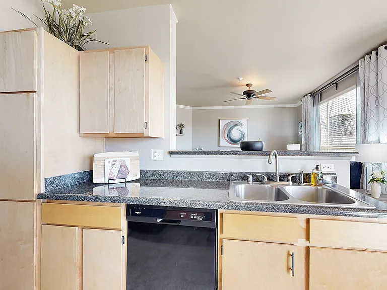 Experience the seamless flow from kitchen to living space in this modern apartment.