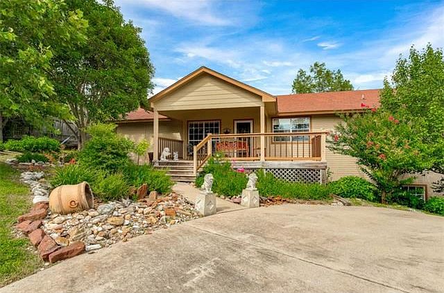 Beautifully landscaped home sits on top of the hill