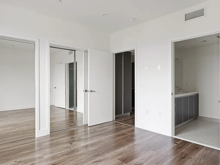 Bedroom with Two Mirrored Closets and Bathroom