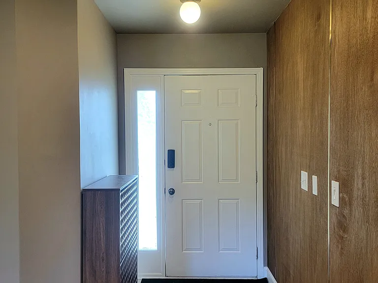 Clean and inviting entryway with a shoe closet.