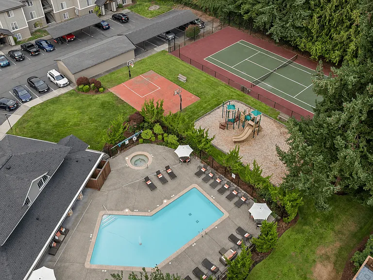Aerial view showcasing the pool, spa, and recreation courts at Willow Hill Apartments.