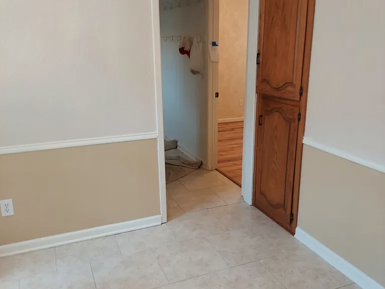 View from kitchen toward 4th bedroom and hallway to garage