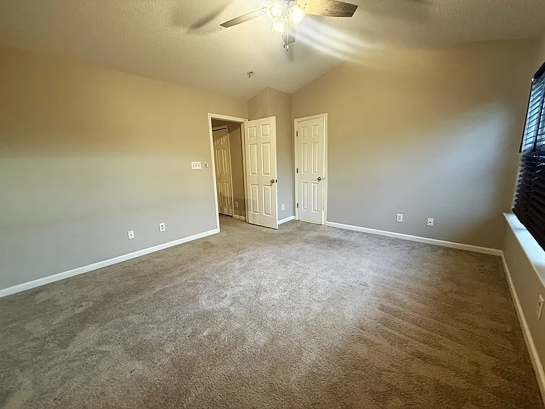 Primary Bedroom includes vaulted ceilings, private bath, and walk-in closet.