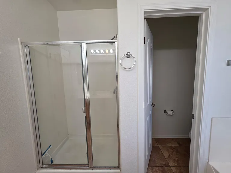 Master bedroom shower and separate toilet