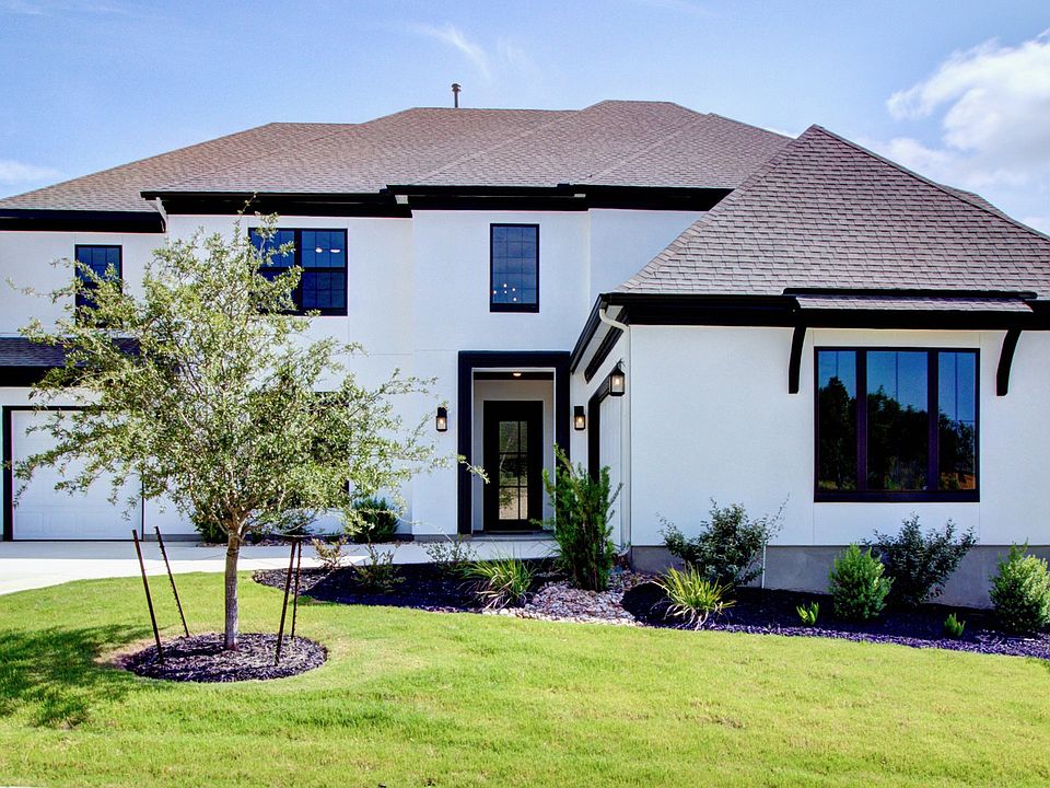 Elegant two-story residence features striking gable roof and expansive windows in Verandas at the Ri