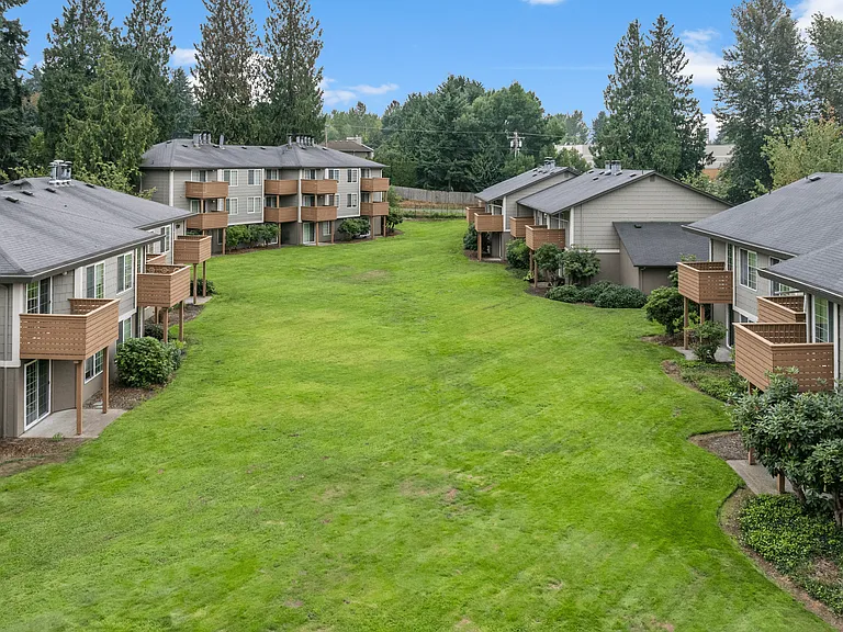 Expansive courtyard surrounded by apartment homes with private balconies.