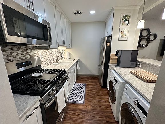 New appliances: microwave, gas stove-top, high-end dishawasher, refrigerator, and GE side-load washer & dryer.