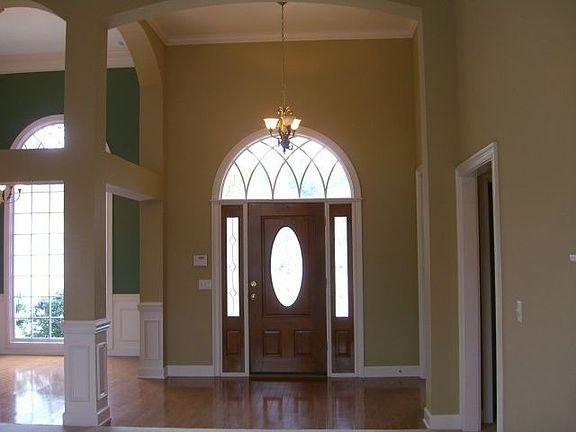 Front Entry/foyer-Hardwood flooring. Partial view of large window in dining Rm