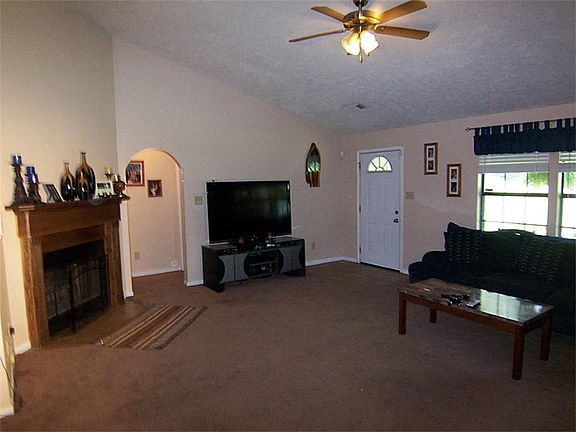 ENTRY WAY AND LIVING ROOM VIEW , WOOD BURNING FIREPLACE