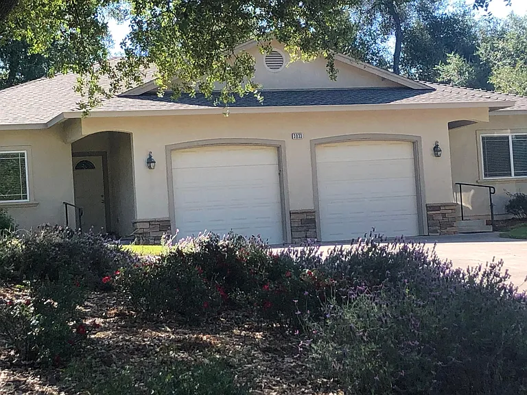 Front of duplex. Single attached garage on the right.
