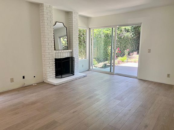 Hearth room looking out to patio, landscaping will be getting a re-fresh and window treatments and baseboards still not installed.
