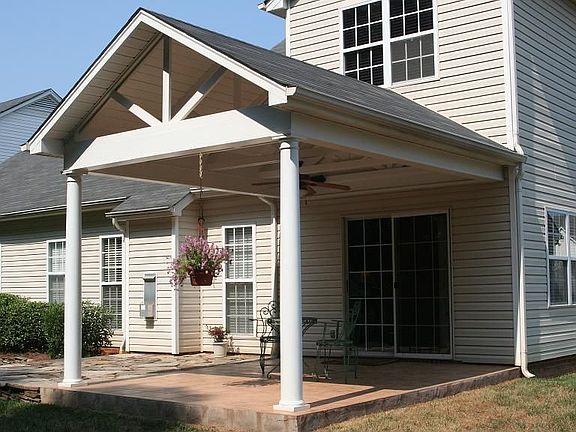 Covered patio with tiled floor, ceiling fan, and outside speakers.