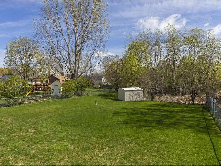Fenced backyard with shed