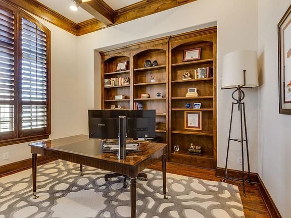 The office/study is located off the foyer and has hardwoods and a beamed ceiling.