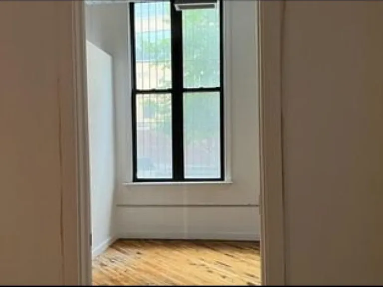 A view inside the bedroom and it's beautiful windows.