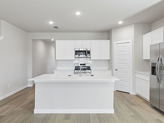 Kitchen in the Holden home plan by Trophy Signature Homes - REPRESENTATIVE PHOTO