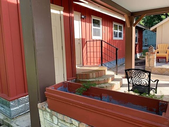This photo shows the steps and back door, as well as the extended water softner closet, which has some storage.