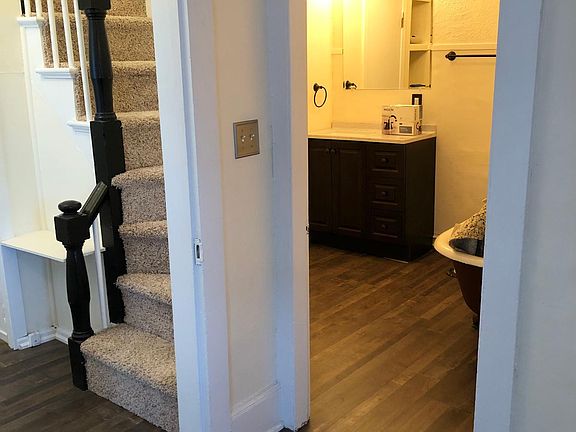 Entryway with bathroom and stairs to bedroom
