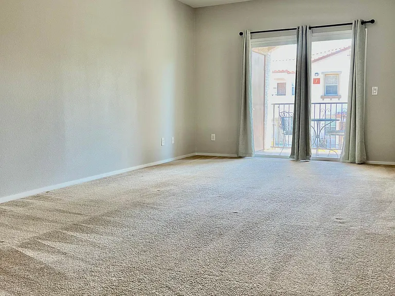 a big size primary bedroom with a patio door, which connects to a private balcony