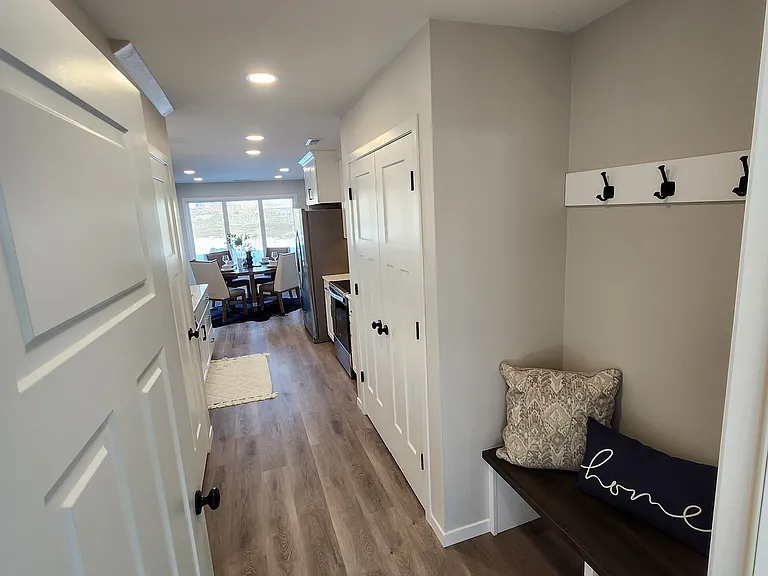 View from garage entrance hallway looking toward kitchen. (Pictures are of another unit with similar finishes and features.)