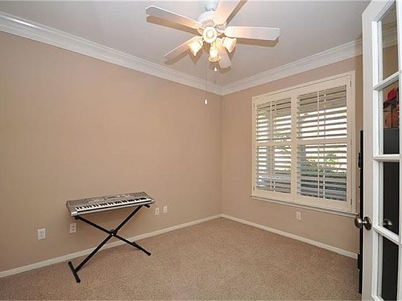 The study greets you to the right of the home. It has plantation shutters, french doors, and plenty 