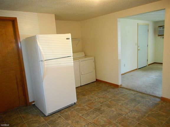 Kitchen looking into Living Room with front door entrance.