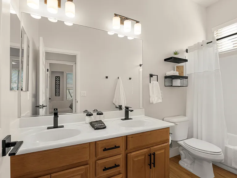 Primary Suite bathroom - with deep soaking tub, glass-enclosed walk-in shower, and dual vanities with natural light.