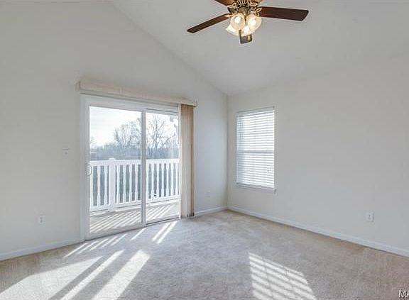 The light filled living room with sliding glass doors that lead