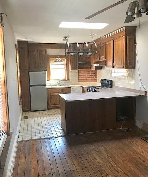 Den/dining area looking into kitchen. Large granite countertop which can used as bar with chairs under this side.
Some tenants have used this area as a den and used the large bar as dining table.