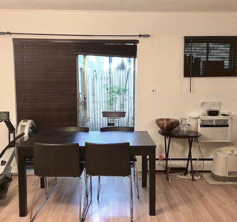 _Dining room/Living room, facing private patio. Blinds and A/C included. Other furnishings not included.