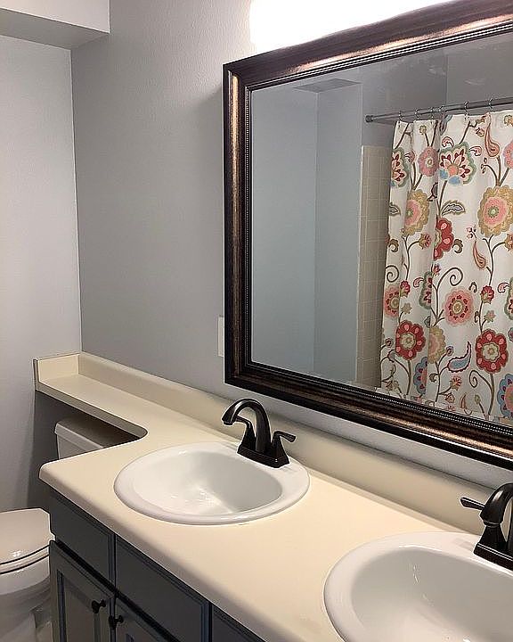 Newly remodeled hall bathroom with double sink vanity, new lighting and plumbing fixtures, new mirrors and new flooring.
